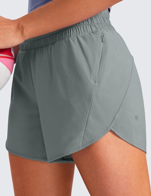 CRZ YOGA Dolphin Athletic Shorts - Mid-Waisted Quick-Dry Running Shorts with Zip Pocket for Women